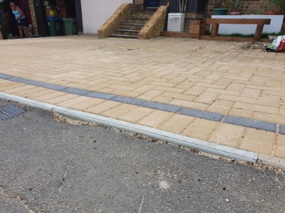 Buff paved driveway with single strip charcoal border