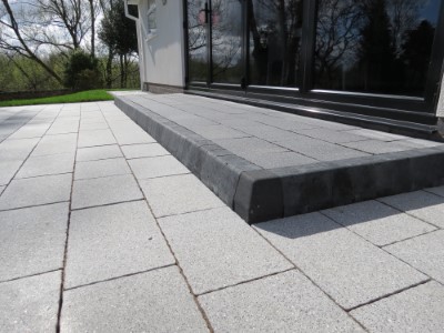 Square kerb step capped with slabs