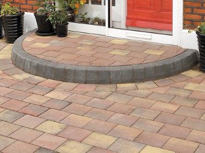 Standard kerb step filled with paving