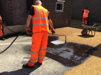 Spraying down hot bitumen on driveway in Somerset